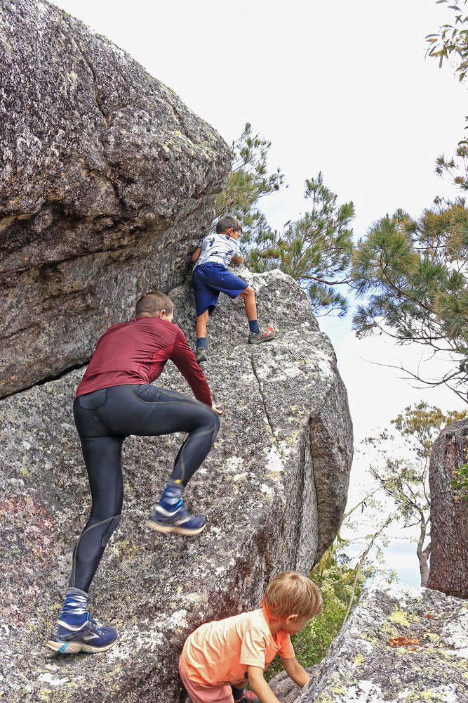 Climbing a rock to get a bird’s eye view from the summit of Walshs Pyramid.