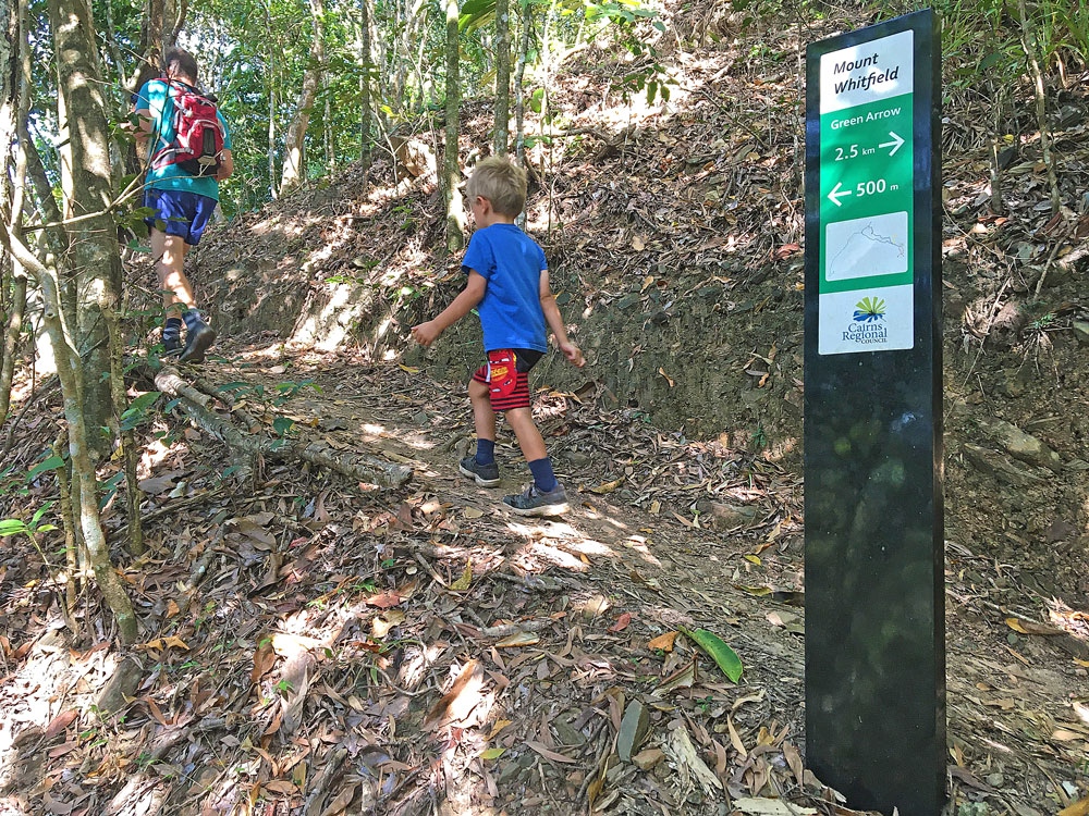 Signage along the Green Arrow Cairns walking track indicate the distance each way.