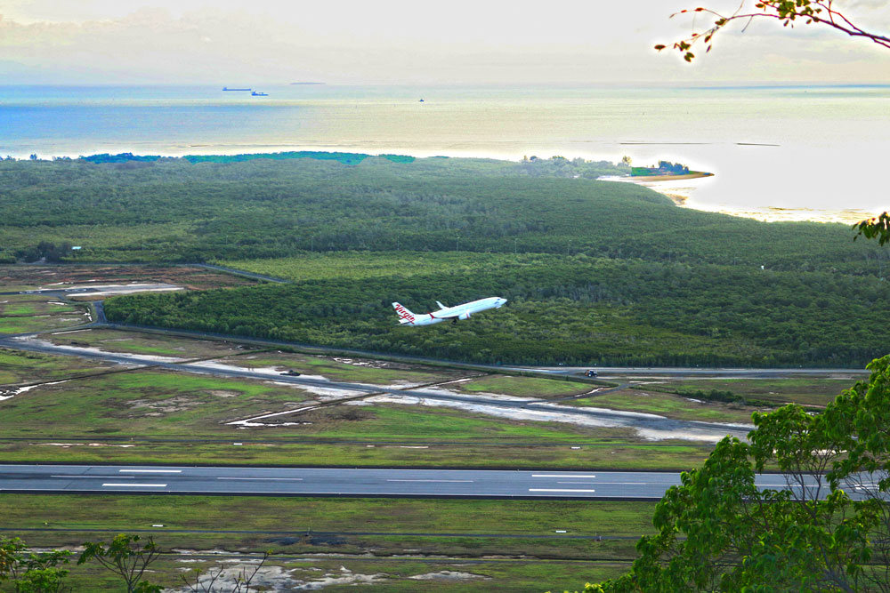 A Virgin plane takes off from the Cairns airport - as seen from Red Arrow lookout. 